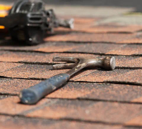 roof repair tools on asphalt shingles